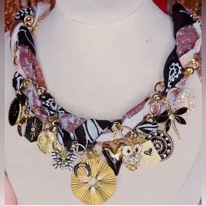 New. Never worn. Handmade Gold and Black Charm Necklace